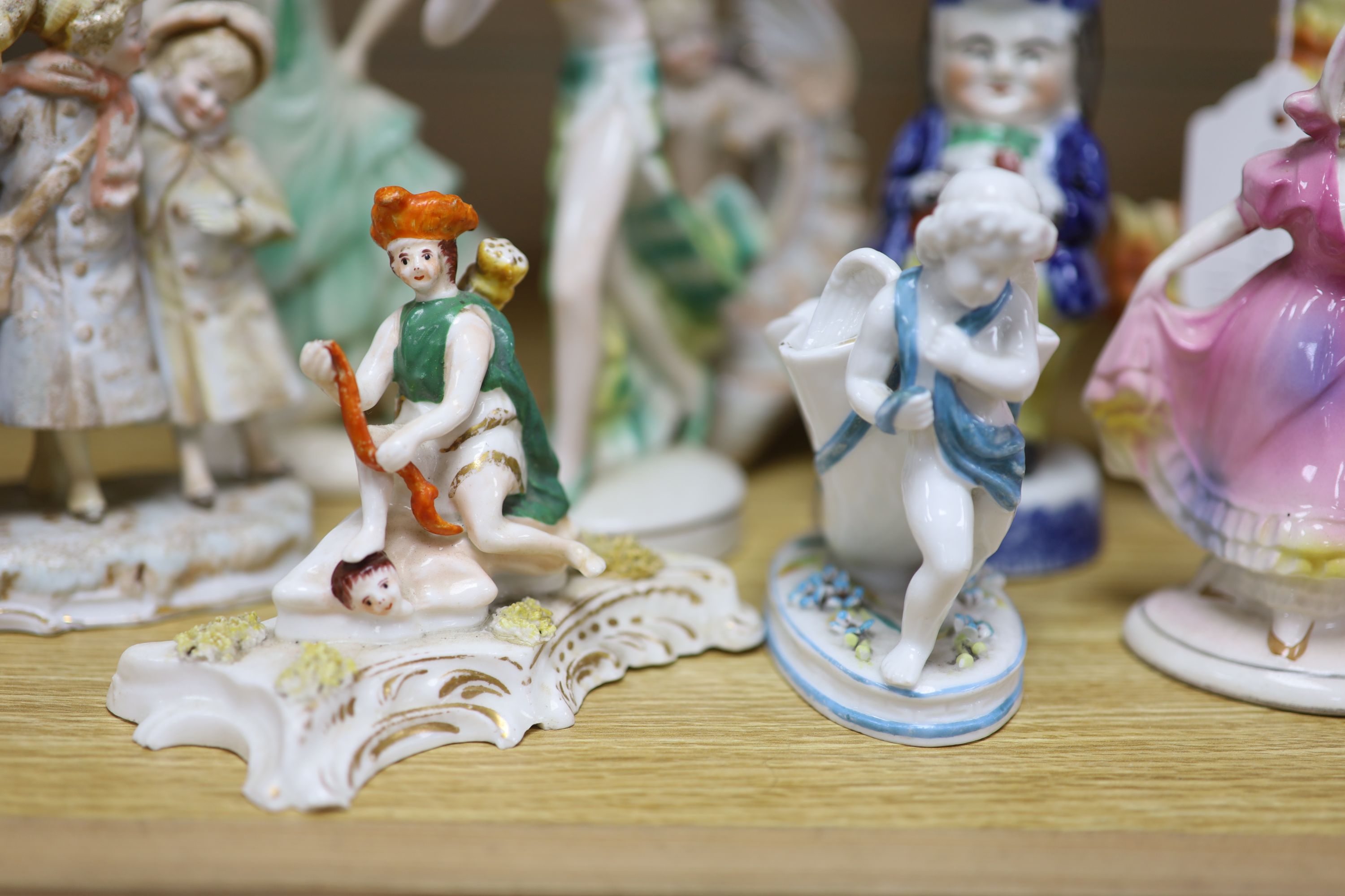 A collection of Art Deco ceramic dancing ladies, a 19th century figural box, a candlestick and a Toby jug, etc., tallest 22cm